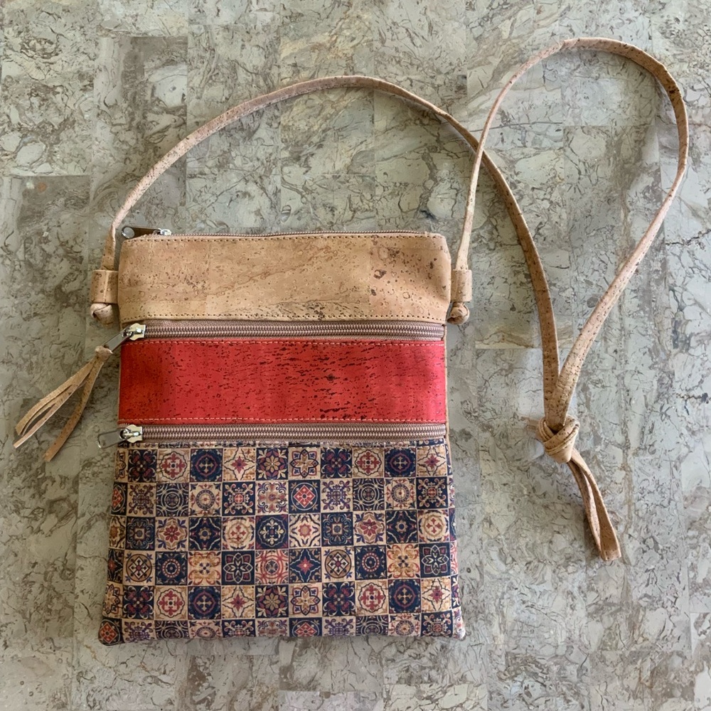 Bohemian style bag with three compartments. Smooth, soft leather-like feel.